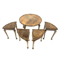 Early 20th century walnut nest of five tables, the larger circular table with pie crust top, and all raised on leaf carved cabriole supports 