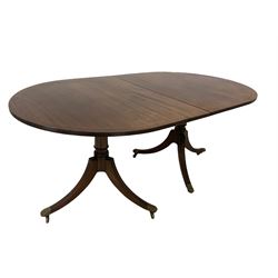 Regency design twin pillar dining table, the oval top with chequered string inlay with one additional leaf, over turned columns and triple splay supports terminating in brass hairy paw cup castors 