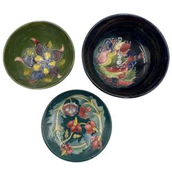 Three pieces of Moorcroft to include a William Moorcroft Leaf and Berries pattern bowl on blue ground D13cm, Columbine pattern bowl and a Leicester pattern pin dish (3)