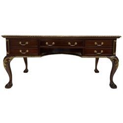 Mahogany writing desk, the rectangular top with gilded and moulded edge over one long and four drawers, raised on ball and claw supports with gilded acanthus leaves 