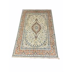 Persian Meshad hand knotted ivory ground carpet, centred by lozenge medallion and decorated with scrolled foliate, 305cm x 200cm