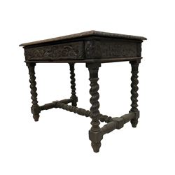 Late 19th century gothic revival oak side table, rectangular top with moulded and carved edge, the single drawer carved with green man handle flanked by trailing foliage, the corners applied with carved flower head motifs, raised om spiral turned supports united by barleytwist stretcher