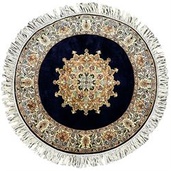 Persian Kashmir ivory ground silk pile circular rug, the solid indigo field decorated with a central floral medallion, the banded border with repeating interlacing palmette motifs