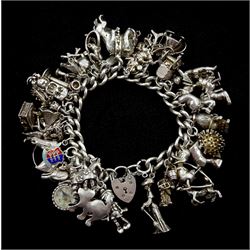 Heavy silver charm bracelet, charms including bulldog, duck, horse, gramophone, Minnie Mouse, bear and elephant