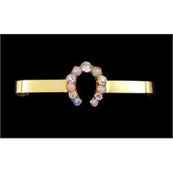 Victorian opal and diamond horseshoe brooch, five graduating old cut diamonds, with six graduating opal set between, stamped 15ct