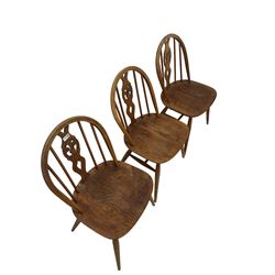 Ercol - set six dining chairs, the spindle and splat back over elm seat, raised on turned supports, united by stretcher 
