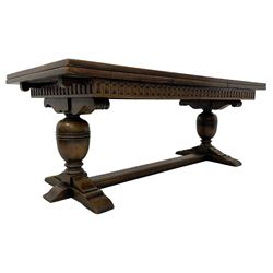 Large Jacobean design refectory dining table, rectangular draw leaf action extending top, arcade carved frieze rails, twin turned baluster supports on shaped sledge feet connected by floor stretcher 