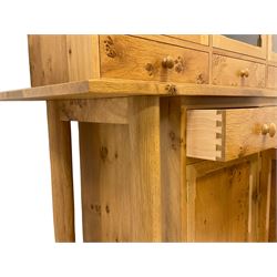 Treske Furniture - figured and burr oak dresser, the upper section enclosed by three glazed doors over three drawers, the lower section with rectangular top over three drawers and three panelled cupboards, on turned tapering supports