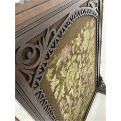 Victorian mahogany fire screen, the needlework panel enclosed by pierced fretwork border raised on ring turned uprights leading to sledge supports W62cm