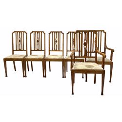 Set Six (4+2) Arts and Crafts period oak dining chairs, rail backs centred by a floral carved and pierced splat, drop in upholstered seat pads, raised on square tapered and splayed front supports W59cm