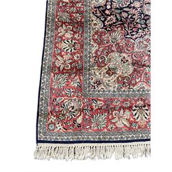Persian design Meshed rug, cotton with silk inlay, the field with central floral medallion surrounded by scrolling and interlaced foliate branches, the guarded border decorated with repeating stylised plant motifs and trailing floral design 