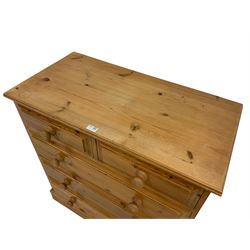 Rustic pine straight-front chest, fitted with two short and three long drawers with wooden handles, on plinth base 