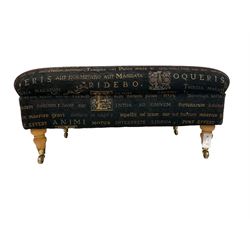 20th century footstool, upholstered in fabric with Latin text and illuminated letters, raised on turned feet with brass castors 