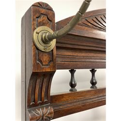 Edwardian oak hallstand, the back with broken arch pediment and spindle gallery over four brass coat hooks, an octagonal bevel edge mirror and tile inserts, over one drawer raised on turned supports united by under tier fitted with two drip trays, W103cm, H207cm, D40cm