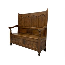 19th century oak settle bench, the high back with four arch shaped panels, scrolled arm terminals with turned arm supports, rectangular seat with hinged lid concealing compartment, the base with two panels to the front with moulded edges