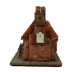 18th century North European amber and tortoiseshell model of a half-timbered, two storey farmhouse, with tiled roof, mother-of-pearl sundial placed beneath the chimney stack and steps leading to the front door, mounted upon a grit-covered rectangular base, H10cm x W10cm