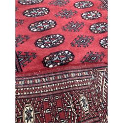 Persian design ground rug, ivory field with border, (140cm x 96cm) together with a Bokhara design ground rug (170cm x 95cm) and a Chinese washed wool ground rug (210cm x 120cm) 