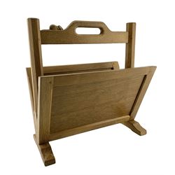 Mouseman - oak magazine rack, shaped cresting rail with pierced handle and carved mouse signature on octagonal supports, two sloping panelled sides on sledge feet, by the workshop of Robert Thompson, Kilburn