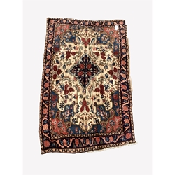  Persian hand knotted cream ground rug, with lozenge medallion surrounded by interlaced foliate, guarded border, 106cm x 171cm  
