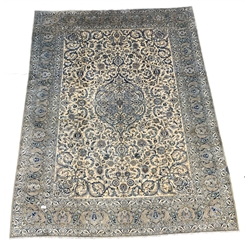 Fine Kashan ivory carpet, blue floral medallion to centre of busy field, enclosed by triple guarded border, 425cm x 323cm