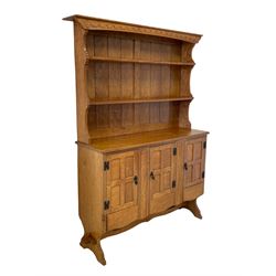'Gnomeman' adzed oak dresser, raised two heights plate rack over rectangular top, three cupboards enclosed by panelled doors each above drawer, carved linen fold uprights, shaped end supports joined by shaped pegged stretcher, carved with gnome signature, by Thomas Whittaker of Littlebeck, W140cm, H184cm, D40cm