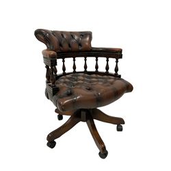 Leather swivel office chair, the chesterfield cresting rail and seat, raised on an oak swivel base