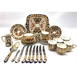 Royal Crown Derby Duesbury pattern tea set Patt. 2451 comprising six cups and saucers, six plates, bread and butter plate, milk jug and sugar bowl, six Derby pistol handled knives, cheese knife, butter knife and a cake knife