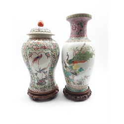 20th Century Chinese baluster vase decorated with script, birds and flowers on a wooden stand H45cm and a vase and cover with panels of figures and birds H41cm