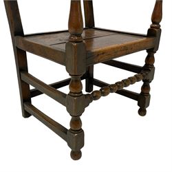 17th century design oak armchair, the back carved with trailing foliage and with turned spindle supports, the uprights mounted with split turnings and with scrolled terminals, panelled plank seat, on turned supports joined by bobbin turned and plain stretchers