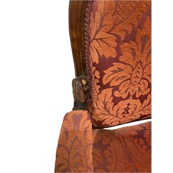 Victorian settee, the walnut show frame with carved foliate motifs and upholstered in floral red fabric W181cm