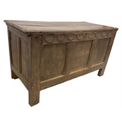 18th century oak coffer or chest, rectangular hinged two-plank top with moulded edge, the frieze carved with lunette C-scrolls over triple panelled front, raised on stile supports