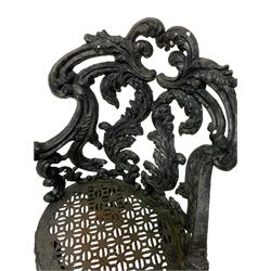 Late 19th century painted heavy ornate cast iron garden chair, the cartouche scrolled cresting rail over pierced foliate design back with trailing scrolls, the seat with pierced geometric fretwork