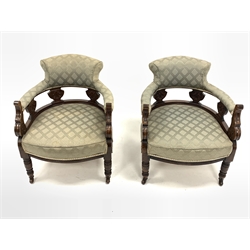 Pair late Victorian carved walnut framed tub shaped salon armchairs, upholstered in patterned green fabric, raised on turned supports and castors, W65cm  