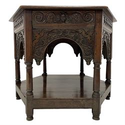 17th century oak centre table, hexagon form, moulded top over cusped and leaf carved frieze, each side with arched panel carved with trailing foliage and berries, on six turned support united by under-tier 