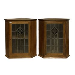 Pair oak corner cabinets, enclosed by lead glazed door