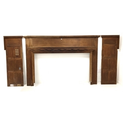 Large Edwardian oak fire surround, gadroon moulded break front cushion frieze over moulded mantel shelf and leaf and floral carved decoration, retaining panelled returns to each end 