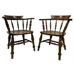 Pair 19th century elm and beech Captains smokers bow chairs, spindle tub shaped back with shaped arm rests, the saddle seat,raised on turned supports united by turned double H stretcher