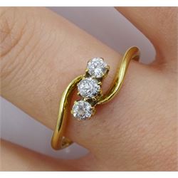 Gold three stone diamond crossover ring, stamped 18ct, total diamond weight approx 0.25 carat