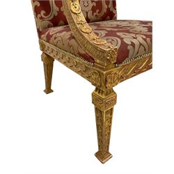 After William Kent - Georgian design giltwood open armchair, scrolled arm supports with scaled sides, acanthus leaf terminal and trailing bellflower decoration, the wide seat, back and arms upholstered in red and silver foliate pattern fabric, the frieze rails decorated with wave decoration and with applied shell motifs, the square tapering supports with vertical bellflowers 