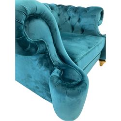 Chesterfield style armchair, scrolled arms and uprights, upholstered in buttoned teal velvet, on turned tapering brass finish feet