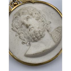 19th century Grand Tour biscuit porcelain portrait plaque, decorated in relief with a bust of the Roman God Jupiter, the plaque claw set to a 9ct gold frame with leaf cresting, H7.5cm x W6.5cm