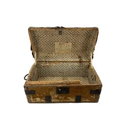 Early 19th century pony hide ladies' travelling trunk, iron mounts, the interior lined with monochrome spotted paper, the domed hinged cover with maker's label to the interior, L56cm x H31cm 