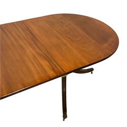 Regency design mahogany twin pedestal extending dining table, oval top with moulded reeded edge, raised on turned vasiform pedestals terminating in splayed reeded tripod bases, with brass hairy paw feet and castors, with additional leaf
Provenance: From the Estate of the late Dowager Lady St Oswald