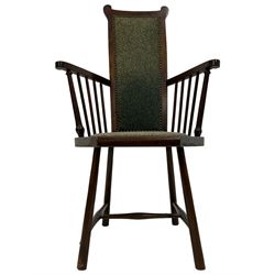 Arts and Crafts Liberty design mahogany framed elbow chair, high back and seat upholstered in foliate patterned laurel green fabric with studwork border, spindle arm supports, raised on splayed supports united by H-stretcher
