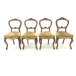 Set four Victorian beech balloon back dining chairs, with floral carved crest rail, upholstered seats, raised on slender cabriole supports 
