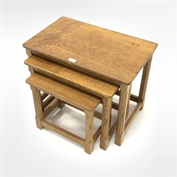 'Mouseman' Yorkshire oak nest of three tables, each with adzed tops, raised on octagonal turned supports and carved with mouse signature, 61cm x 39cm, H50cm
