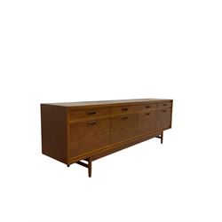 20th century teak sideboard, fitted with four drawers over four cupboards, raised on turned supports 