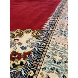 Large Moroccan red ground carpet, the red field centred by medallion and enclosed by similar spandrels and border, 295cm x 463cm
