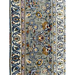 Large Persian ivory ground carpet, the field decorated with interlacing and scrolled branches with stylised plant motifs, repeating border with floral design
