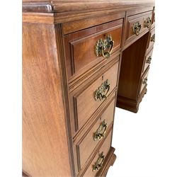 Edwardian walnut twin pedestal desk, the raised back and inset top over one long and eight graduated drawers 